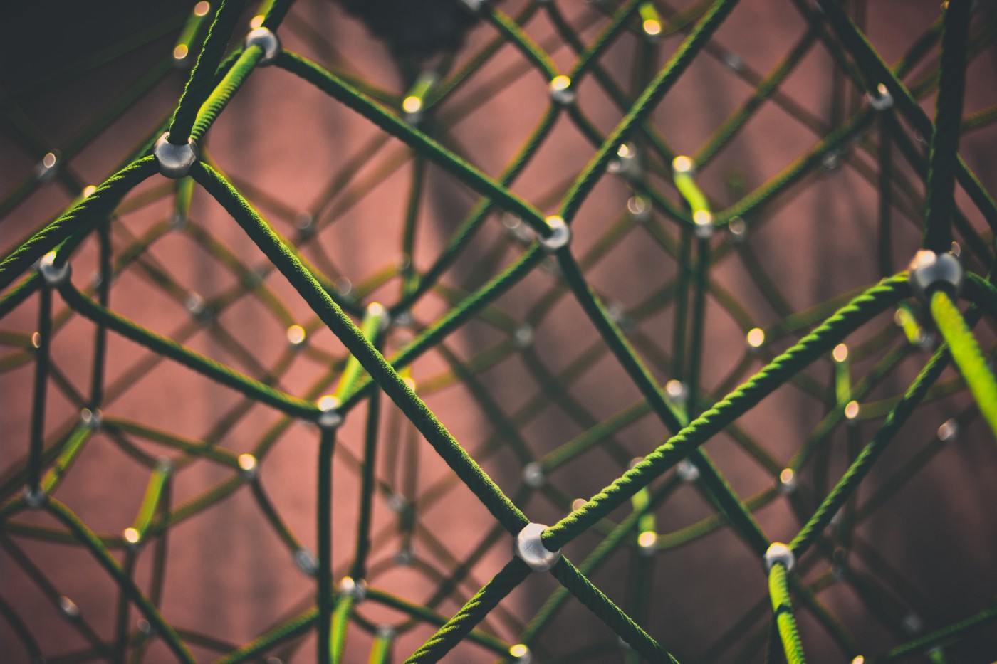 Green ropes tied together forming a tetrahedron-looking object.